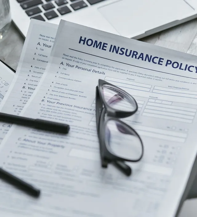 Insurance Policy Document with a Pair of Glasses on Top