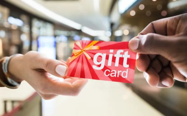 Two hands holding and showcasing a gift card